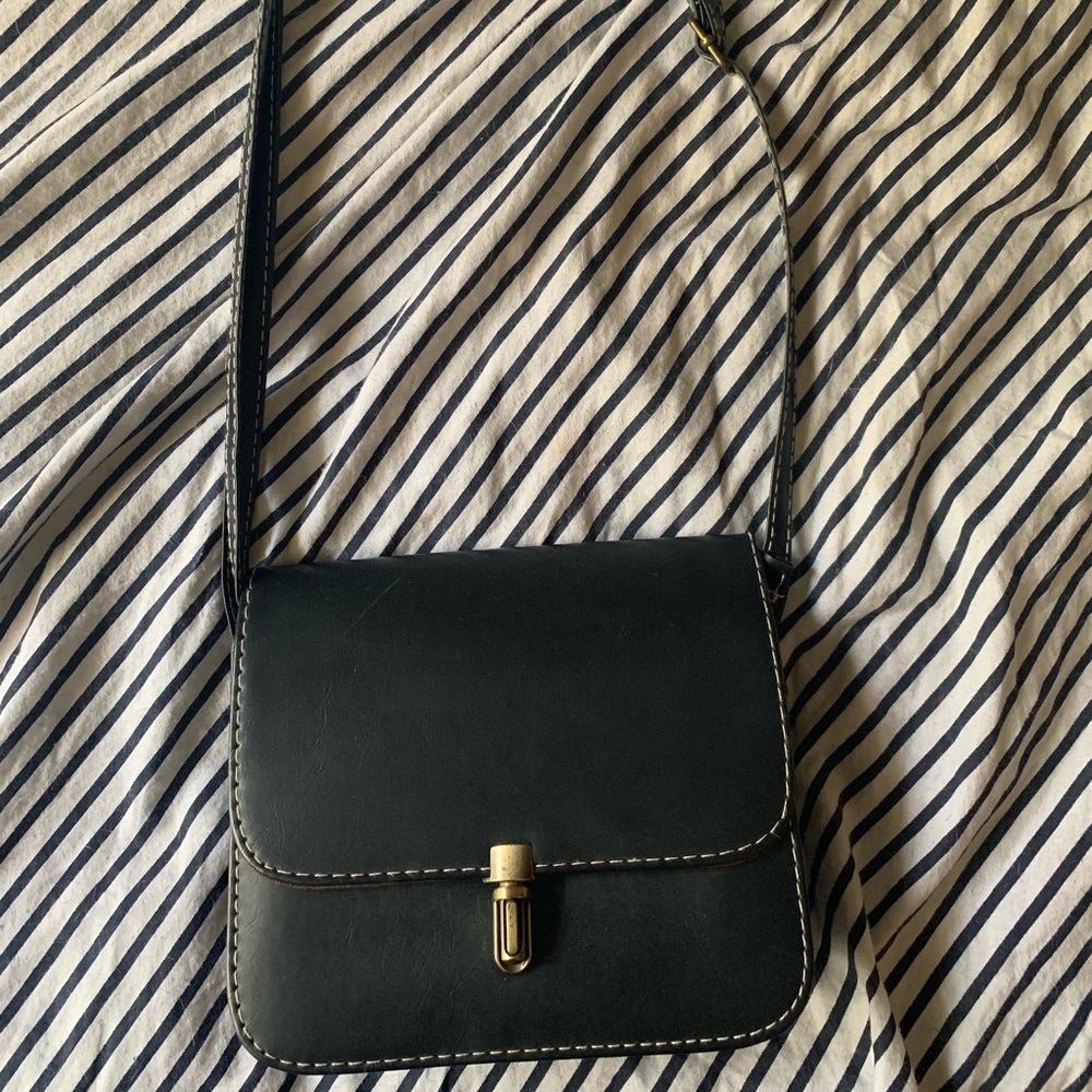 Small black purse with white stitching